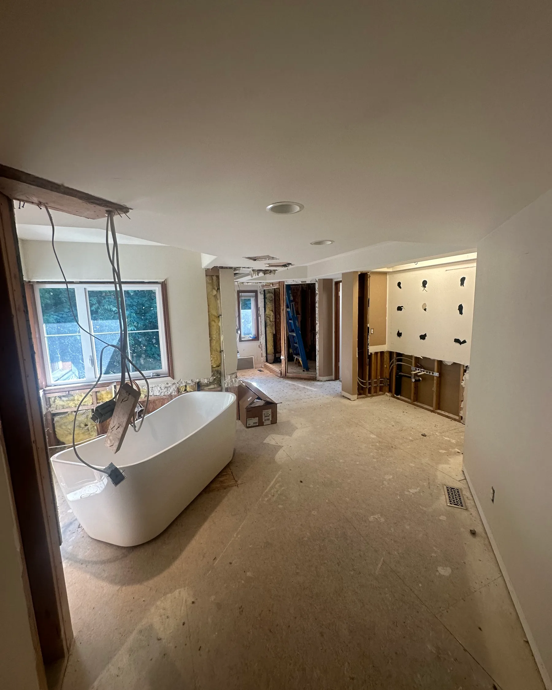 Master bathroom before renovation — room stripped back with the freestanding tub set in place