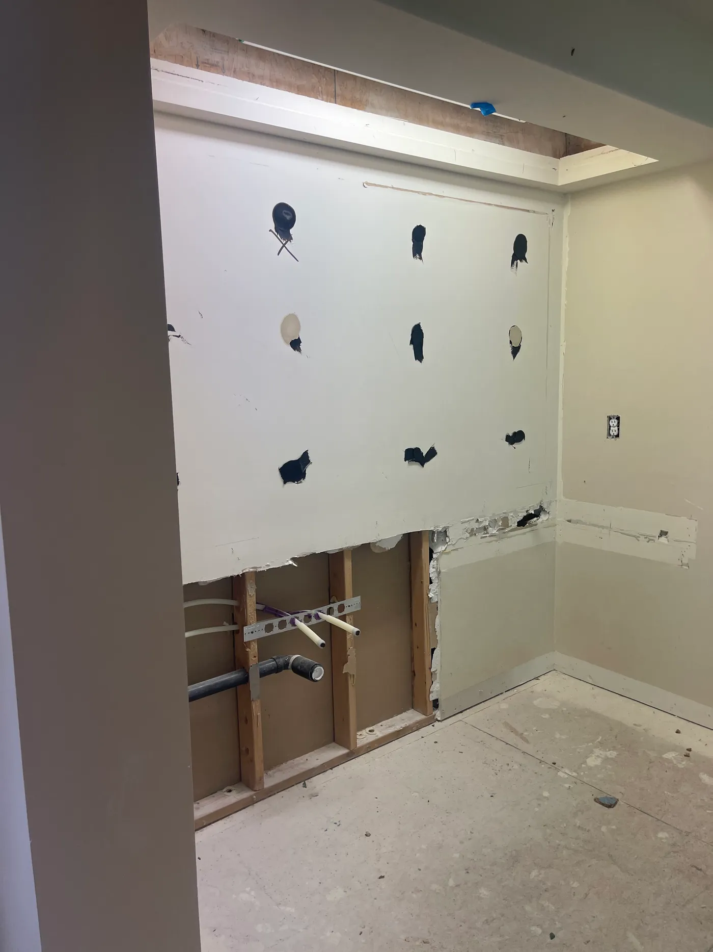 Plumbing rough-in and marked wall positions during the master bathroom renovation