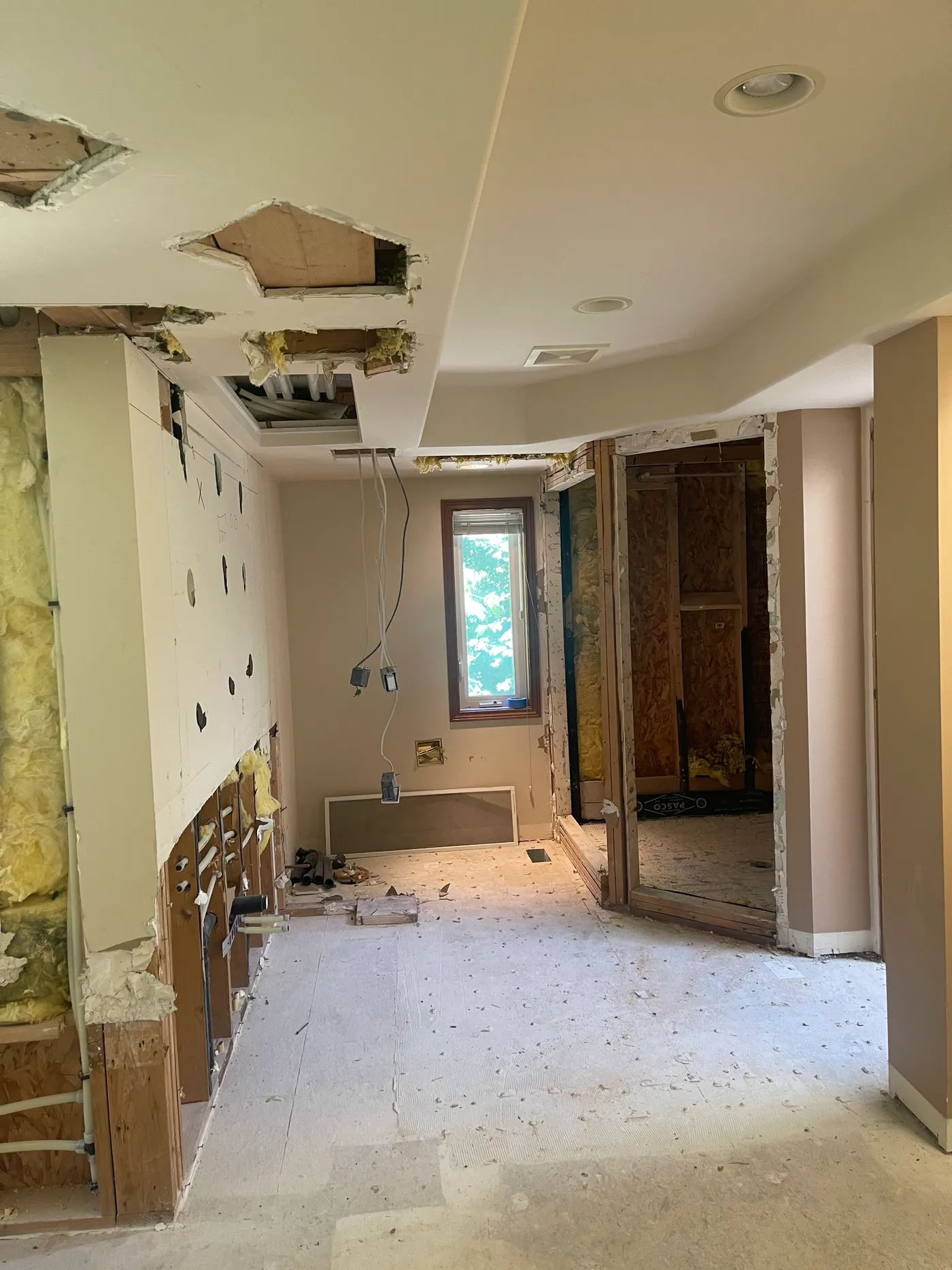 Master bathroom stripped back to studs with the ceiling opened up before renovation