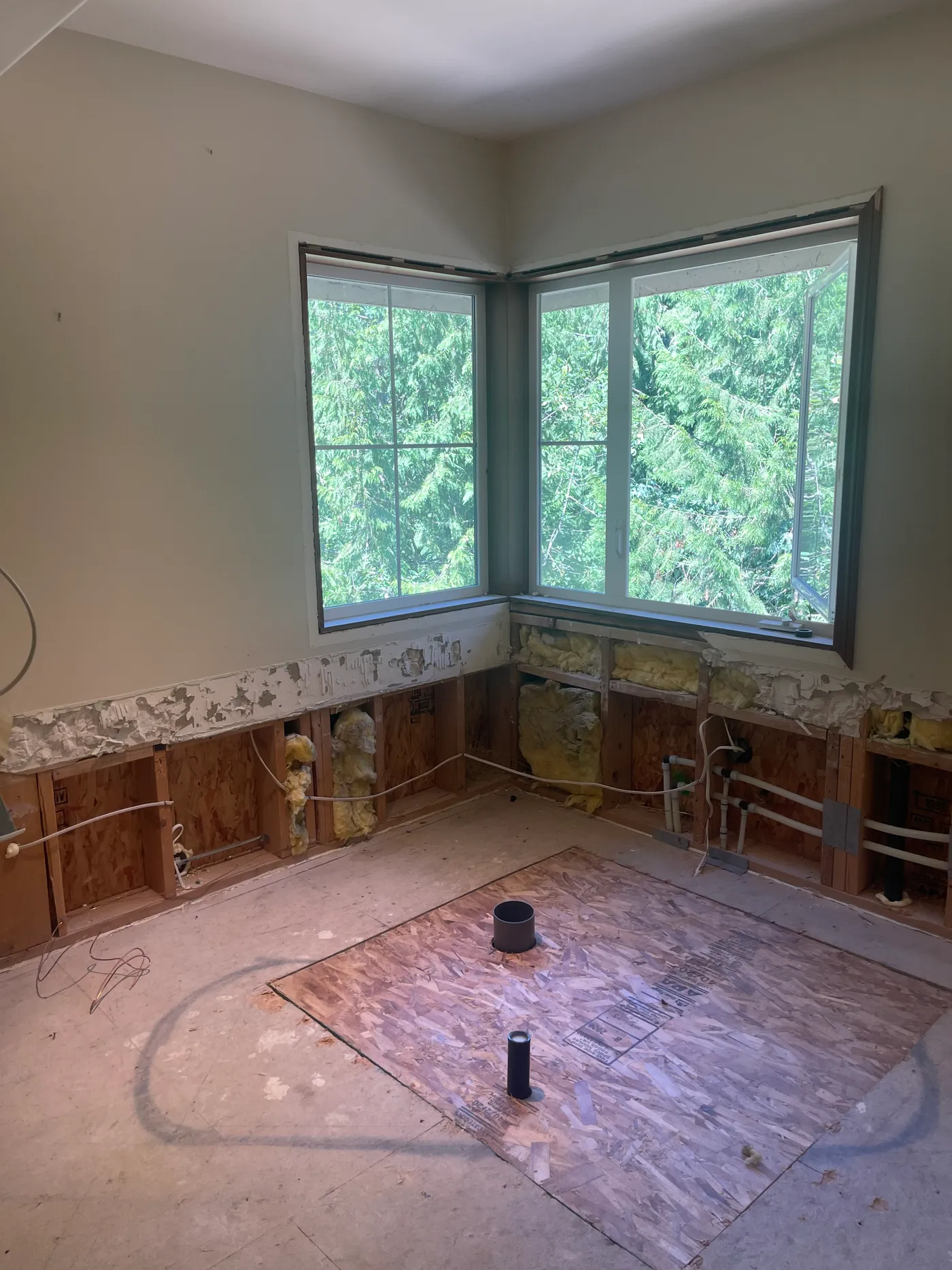 Corner window wall taken back to studs before the master bathroom renovation
